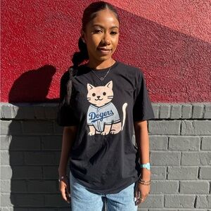 Doyers cat with jersey on black shirt